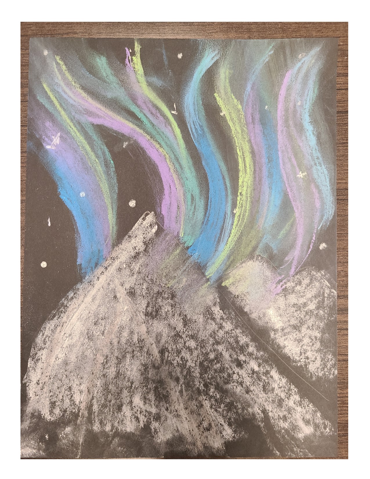 Chalk drawing of wavy blue, green, and purple lines over a mountain on black paper. 