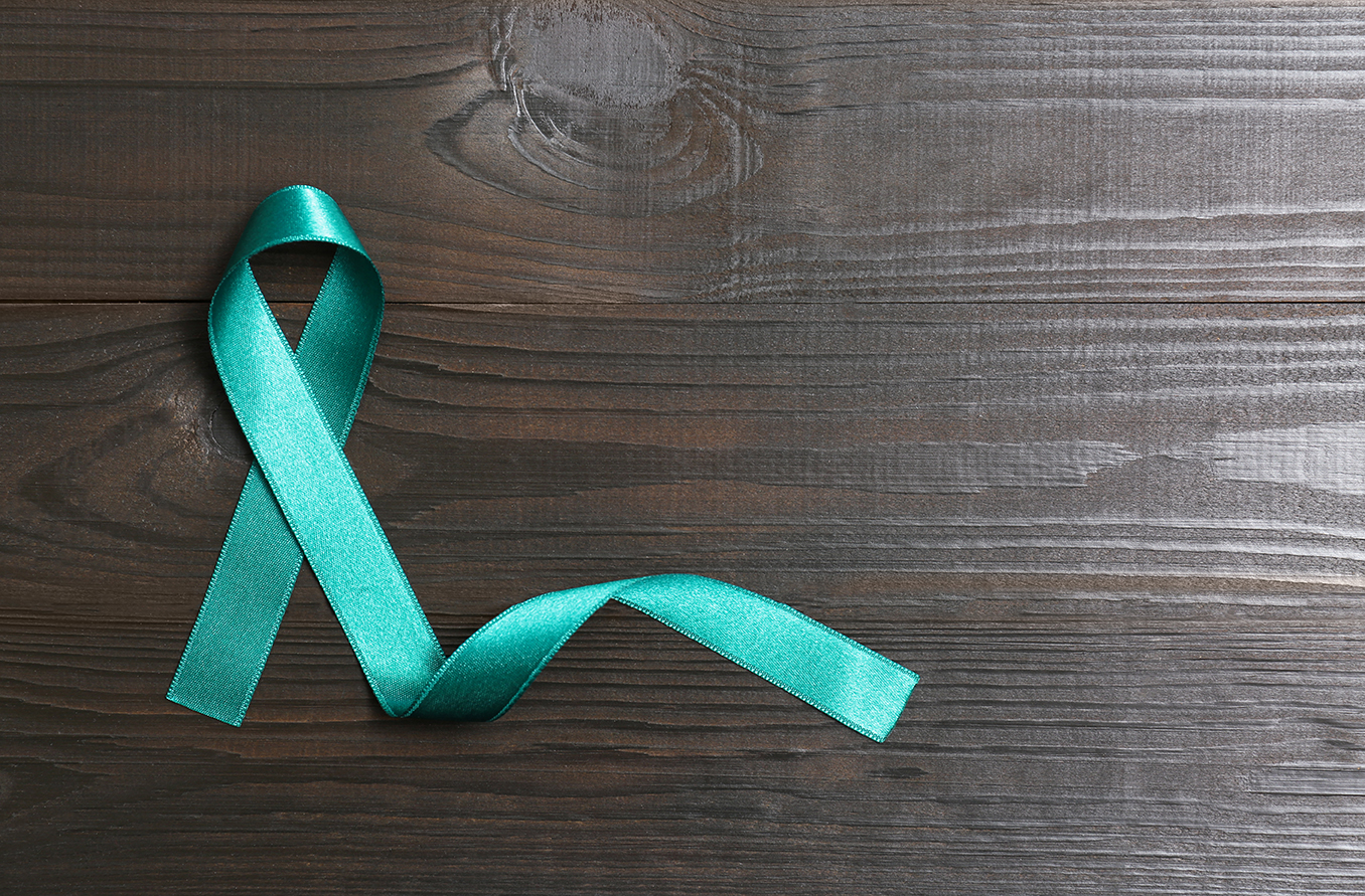 Teal ribbon on a background of stained wood