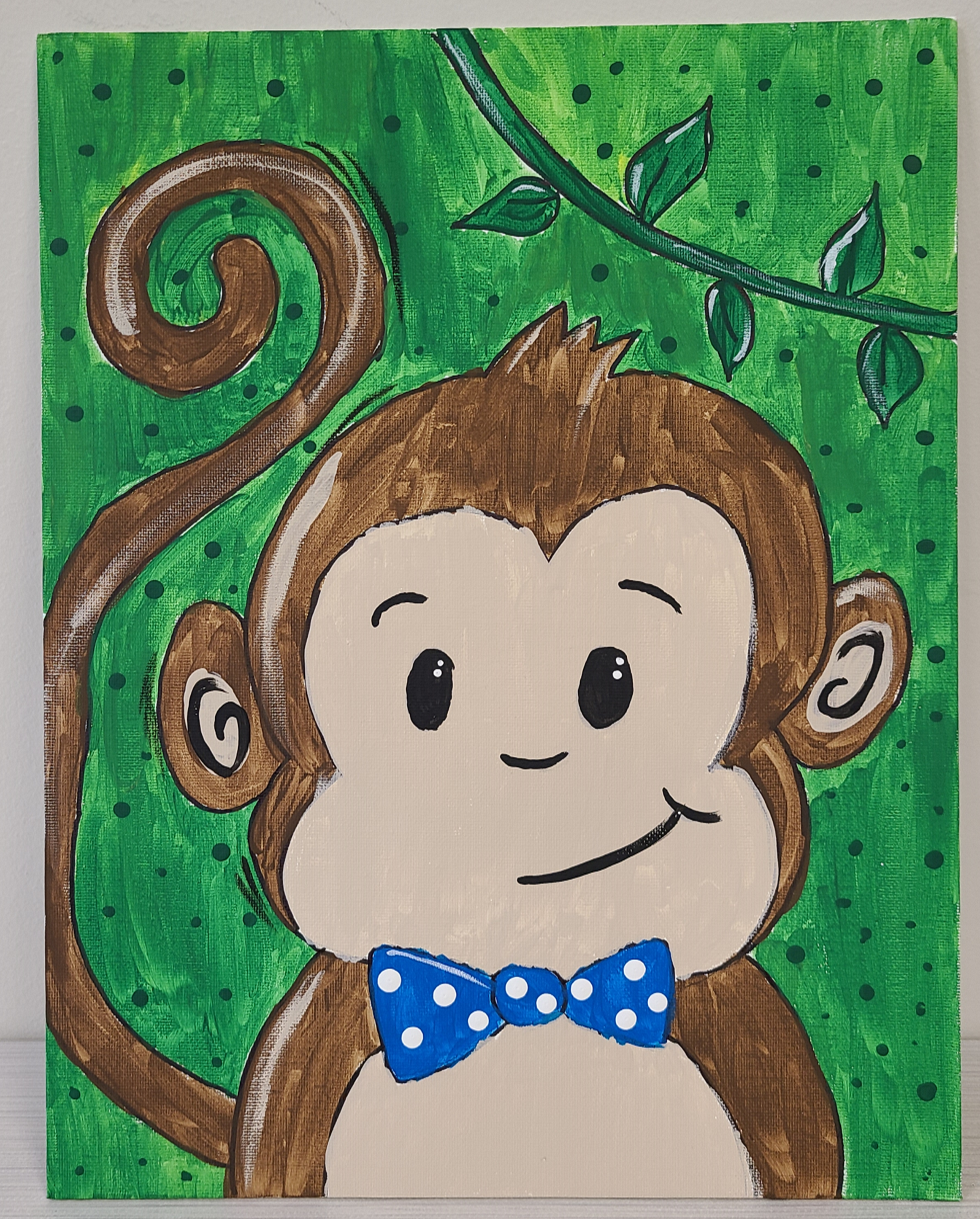 Cartoon monkey with blue bow tie on a green background
