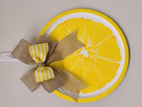 Lemon slice wall hanging with yellow striped ribbon and burlap bow