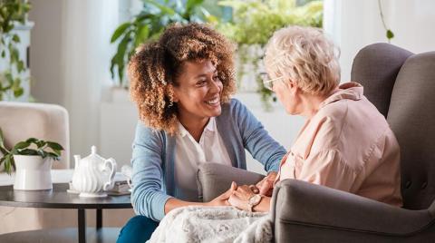 young person sitting with old person