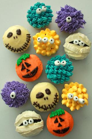 Cupcakes decorated with colorful frosting to look like monsters