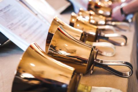 a row of brass bells and sheet music