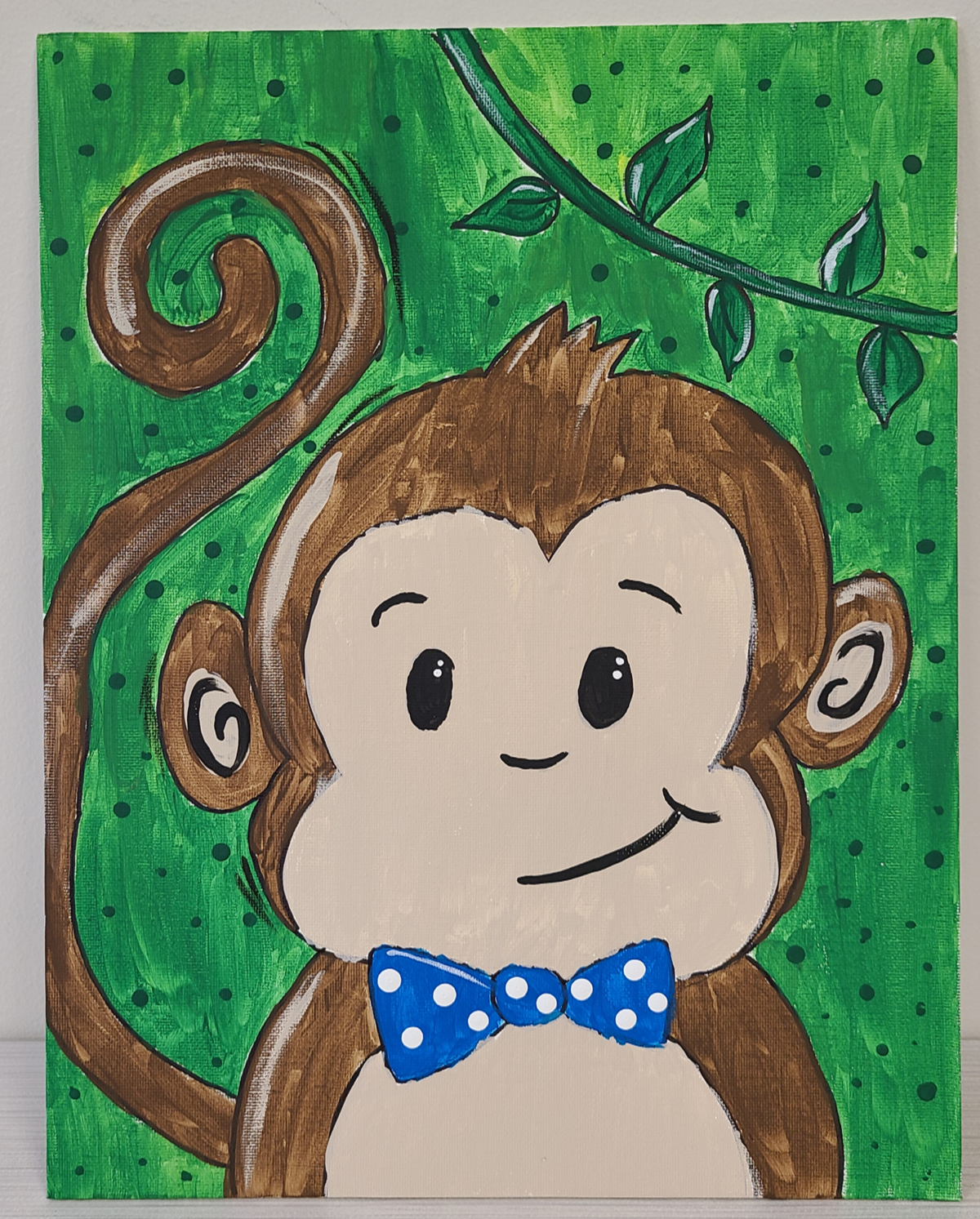 Cartoon monkey with blue bow tie on a green background