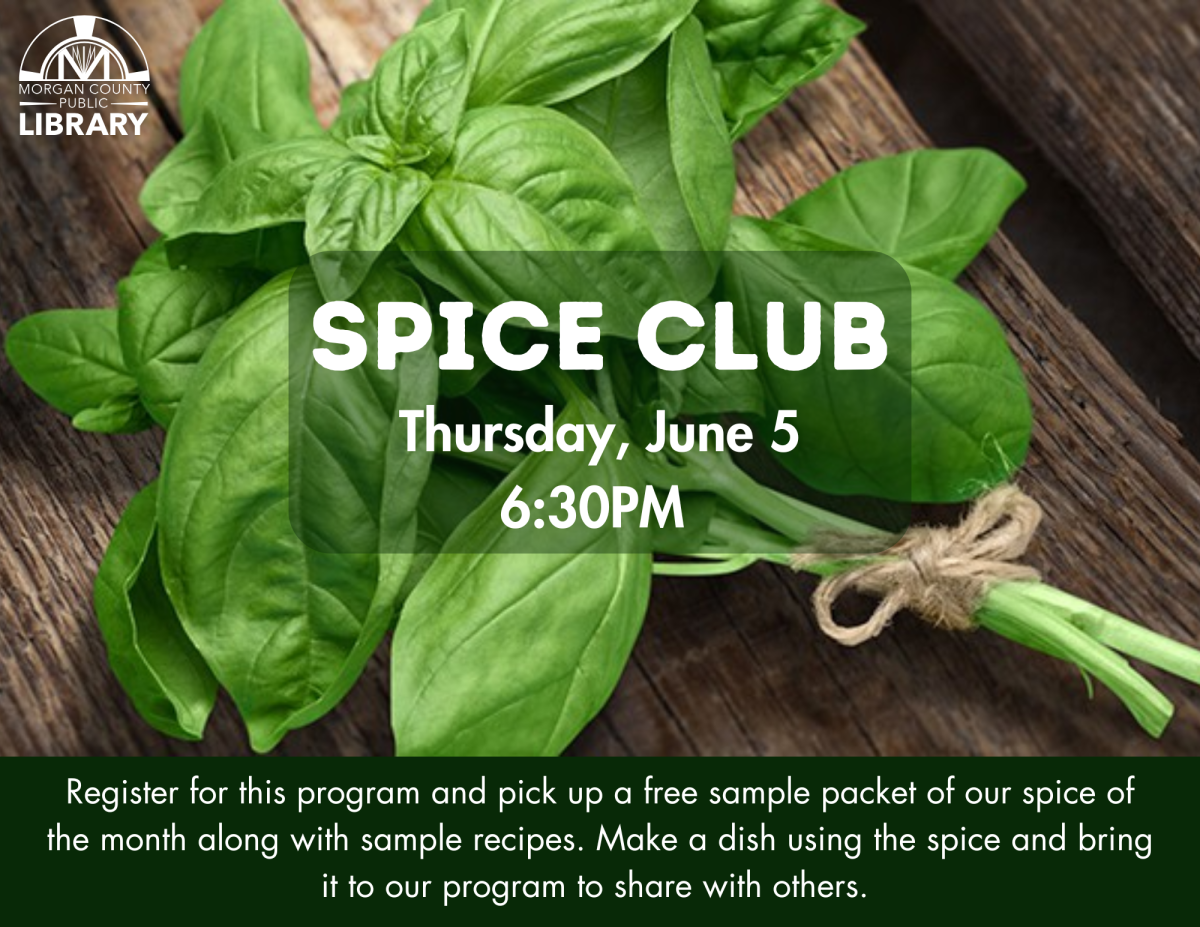 a bundle of fresh basil tied with a string on a wooden background